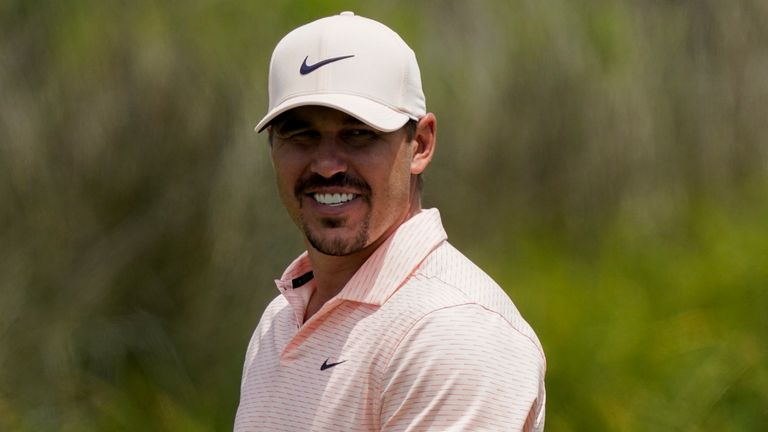 Brooks Koepka smiles on the 12th hole during a practice round at the PGA Championship