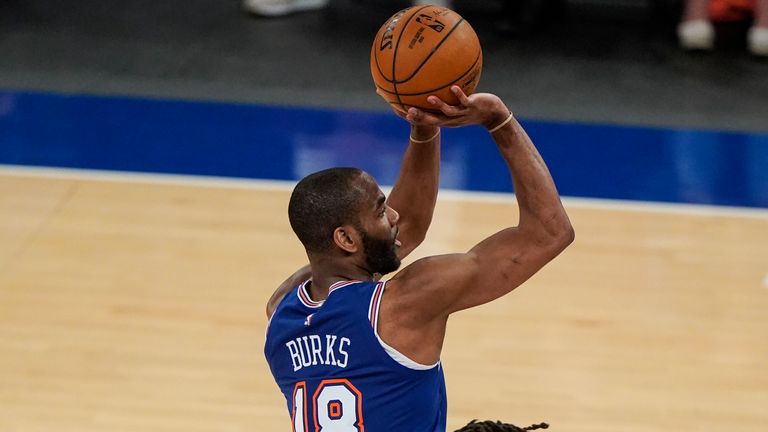 New York Knicks' Alec Burks, left, shoots over San Antonio Spurs' Patty Mills during the second half of an NBA basketball game Thursday, May 13, 2021, in New York. The Knicks won 102-98.