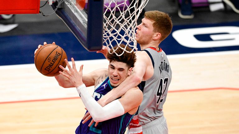 Charlotte Hornets guard LaMelo Ball, left, is fouled by Washington Wizards forward Davis Bertans (42) during the second half of an NBA basketball game, Sunday, May 16, 2021, in Washington. The foul was upgraded to a flagrant one. (AP Photo/Nick Wass)