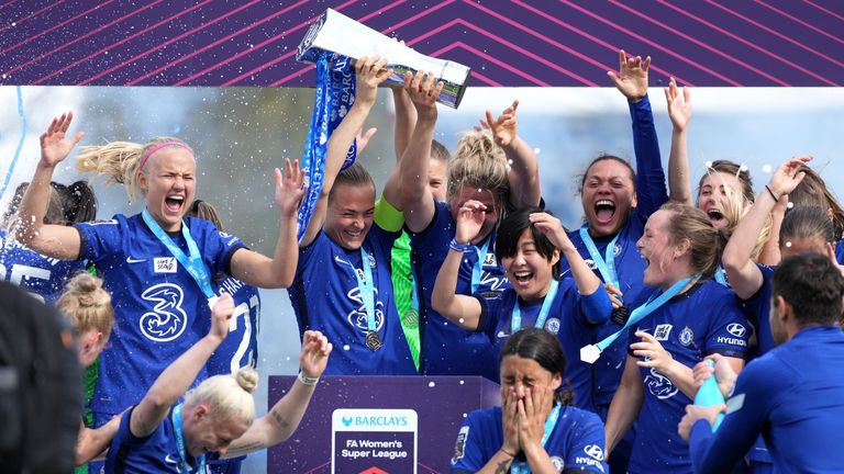 Chelsea players celebrate with the FA Women&#39;s Super League trophy after clinching the title at Kingsmeadow, London. Picture date: Sunday May 9, 2021.