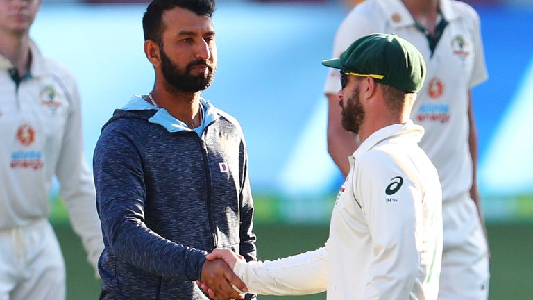India's Cheteshwar Pujara is congratulated by Australia's Matthew Wade