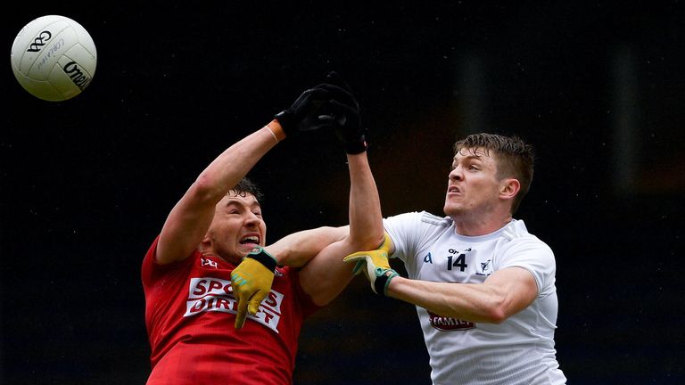 Paul Walsh of Cork is beaten to the ball by Kevin Feely of Kildare