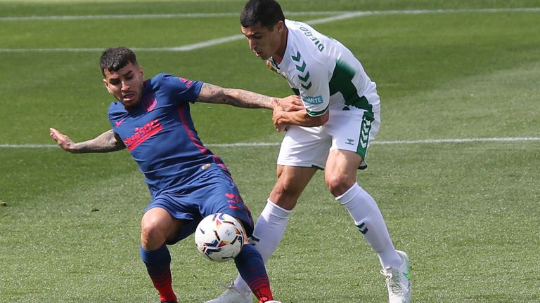 Atletico Madrid's Angel Correa vies for the ball against Elche's Diego Gonzalez