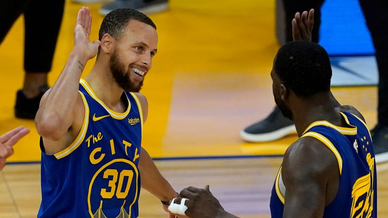 Golden State Warriors guard Stephen Curry (30) celebrates with forward Draymond Green during the second half of an NBA basketball game against the Utah Jazz in San Francisco, Monday, May 10, 2021.