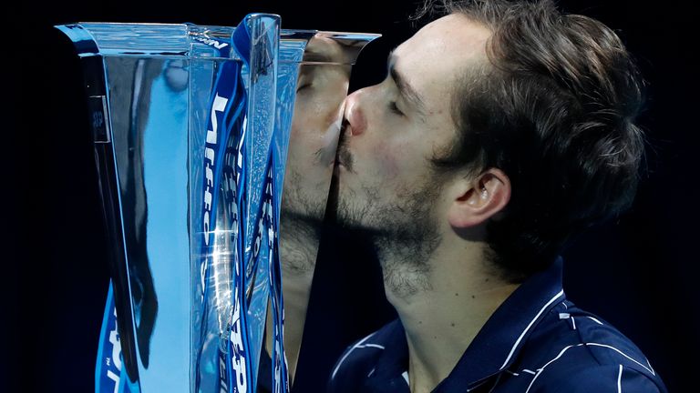 Daniil Medvedev of Russia kisses the winners trophy after defeating Dominic Thiem of Austria in the final of the ATP World Finals tennis match at the ATP World Finals tennis tournament at the O2 arena in London, Sunday, Nov. 22, 2020. (AP Photo/Frank Augstein)