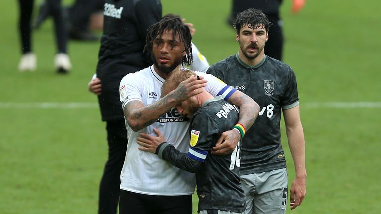 Derby striker Colin Kazim-Richards consoles Sheffield Wednesday's Barry Bannan after the sides' 3-3 draw confirmed the Owls' relegation