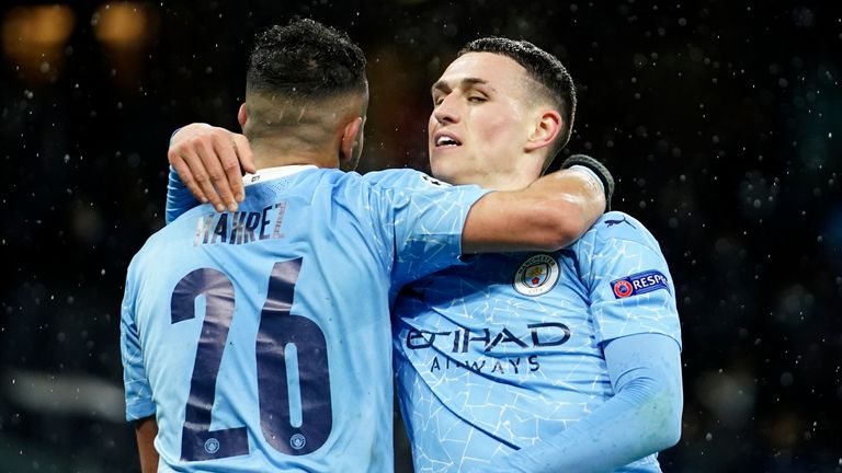 Phil Foden celebrates with Riyad Mahrez