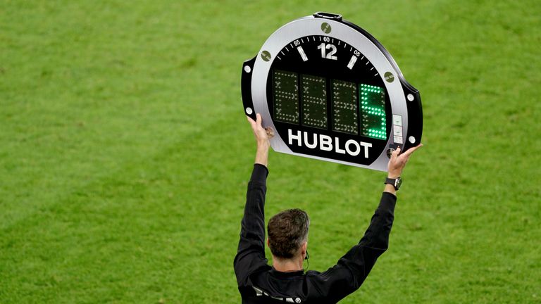PA - Fourth official holds board displaying five added on minutes