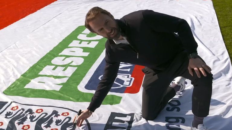 Gareth Southgate provides the first signature to the huge England flag that will tour the country