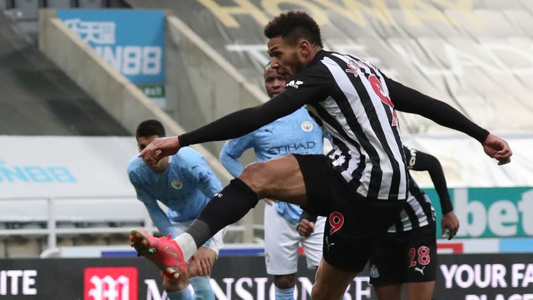 Newcastle's Joelinton, right, scores his side's second goal during the English Premier League soccer match between Newcastle United and Manchester City at St James' Park stadium, in Newcastle, England, Friday, May 14, 2021. (AP Photo/Scott Heppell, Pool)