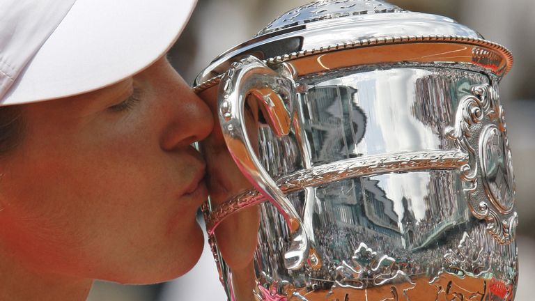 Belgium's Justine Henin kisses the cup after defeating Serbia's Ana Ivanovic in the women's final match of the French Open tennis tournament at the Roland Garros stadium in Paris. 