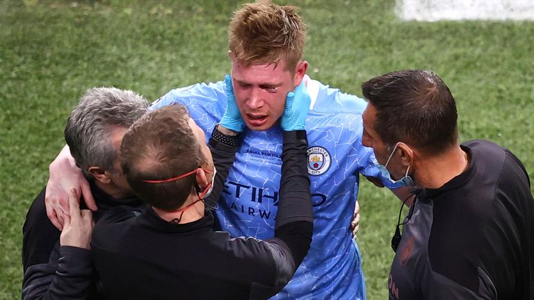 Manchester City&#39;s Kevin De Bruyne is assisted after a foul by Chelsea&#39;s Antonio Rudiger during the Champions League final soccer match between Manchester City and Chelsea at the Dragao Stadium in Porto, Portugal, Saturday, May 29, 2021.