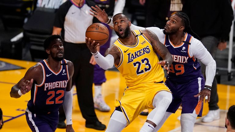 Los Angeles Lakers forward LeBron James scores past Phoenix Suns forward Jae Crowder during the second half in Game 3