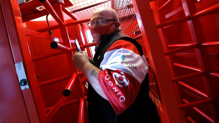 Leigh fans enter the stadium through the turnstiles