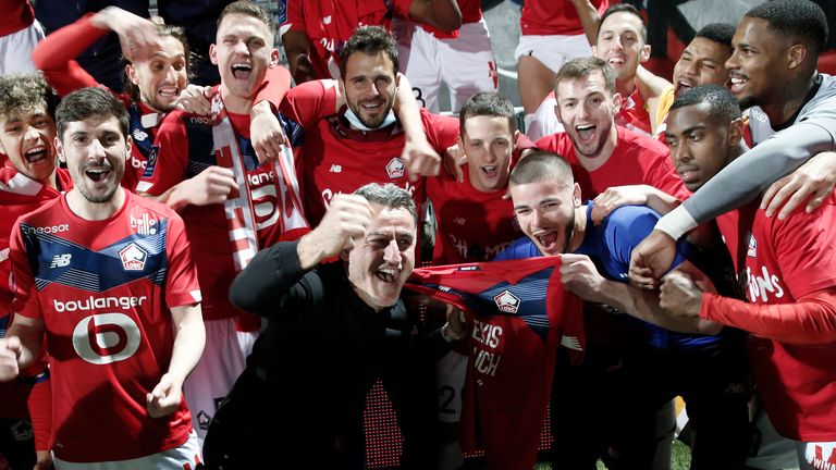 Lille&#39;s head coach Christophe Galtier (centre) celebrates with his players after winning the Ligue 1 title