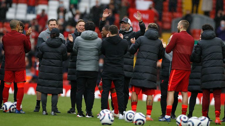 Liverpool's manager Jurgen Klopp and players line up to applaud Liverpool's Georginio Wijnaldum after the English Premier League soccer match between Liverpool and Crystal Palace at Anfield stadium in Liverpool, England, Sunday, May 23, 2021. (Phil Noble/Pool via AP)