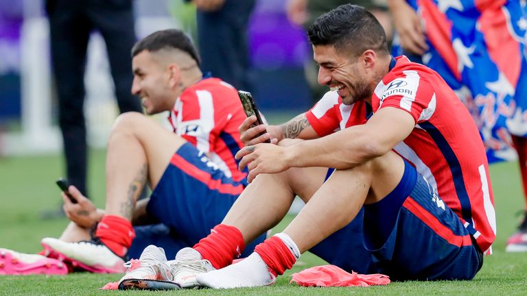 Luis Suarez on his phone after winning the La Liga title with Atletico Madrid