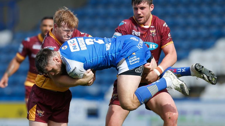 Tom Briscoe is tackled by James Cunningham and Joe Greenwood