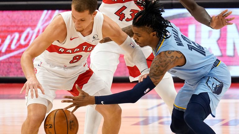 Toronto Raptors guard Malachi Flynn (8) steals the ball from Memphis Grizzlies guard Ja Morant (12) during the first half of an NBA basketball game Saturday, May 8, 2021, in Tampa, Fla. 