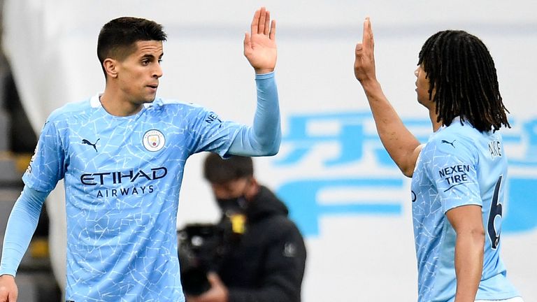 Joao Cancelo high-fives Nathan Ake after equalising for Man City