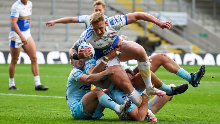 Leeds' Mikolaj Oledzki is tackled by Wakefield's Olly Ashall-Bott and Matty Ashurst.