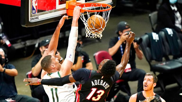 Milwaukee Bucks center Brook Lopez (11) shoots over  center Bam Adebayo (13) during the first half of Game 4 of an NBA basketball first-round playoff series, Saturday, May 29, 2021, in Miami. (AP Photo/Lynne Sladky)