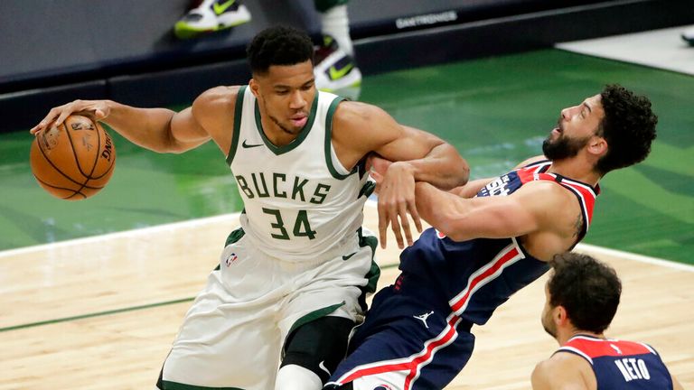 Milwaukee Bucks&#39; Giannis Antetokounmpo (34) commits a charging foul against Washington Wizards&#39; Anthony Gill during the first half of an NBA basketball game Wednesday, May 5, 2021, in Milwaukee. (AP Photo/Aaron Gash)