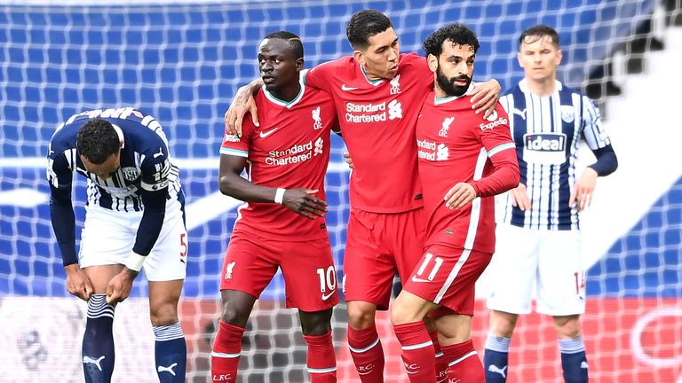 Mohamed Salah is congratulated by teammates Sadio Mane and Roberto Firmino