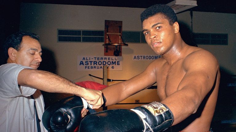 Muhammad Ali gets his gloves laced outside a boxing ring in Houston, Texas in February 1967.  Ali is training for a Feb. 6 championship title fight with Ernie Terrell. (AP Photo)