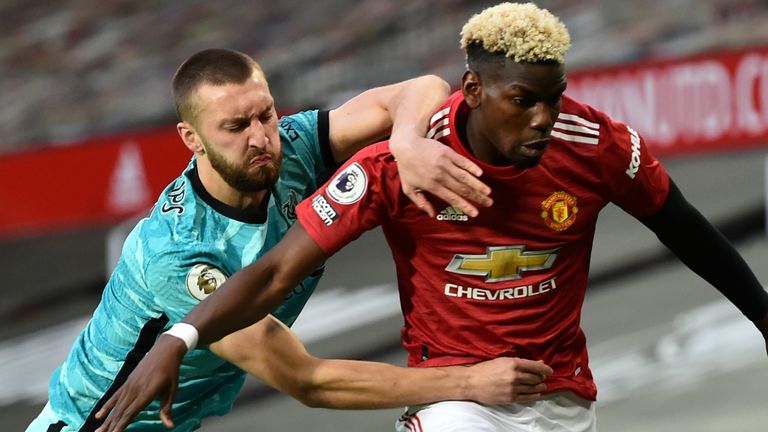 Nat Phillips and Paul Pogba battle at Old Trafford