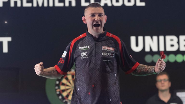 Nathan Aspinall roared to the top of the Premier League table with a brilliant 8-3 win over Michael van Gerwen (Image courtesy of PDC/Lawrence Lustig)