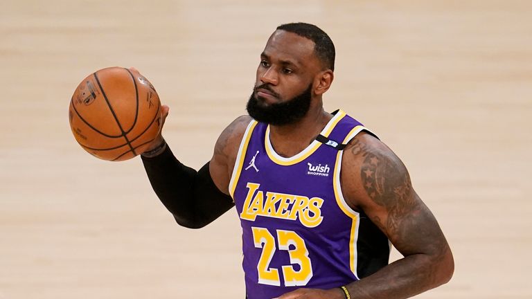 Los Angeles Lakers forward LeBron James dribbles during the first half of an NBA basketball game against the Sacramento Kings Friday, April 30, 2021, in Los Angeles.