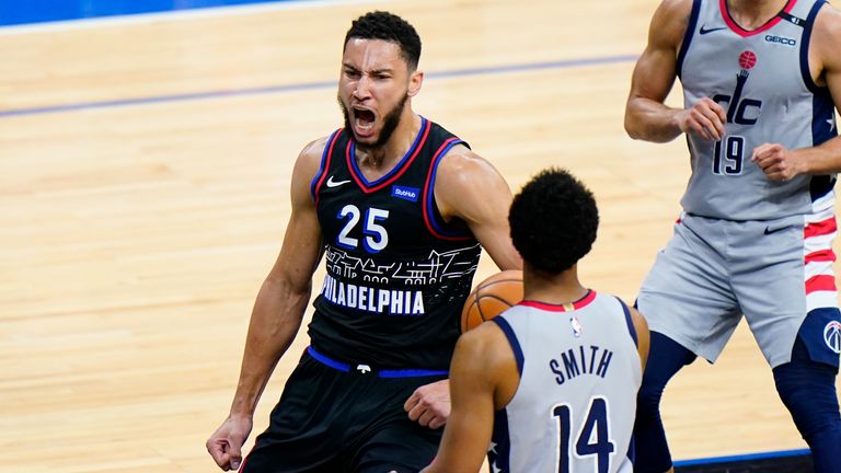 Philadelphia 76ers&#39; Ben Simmons, left, reacts after a dunk as Washington Wizards&#39; Ish Smith looks on during the first half of Game 2 in a first-round NBA basketball playoff series, Wednesday, May 26, 2021, in Philadelphia. (AP Photo/Matt Slocum)


