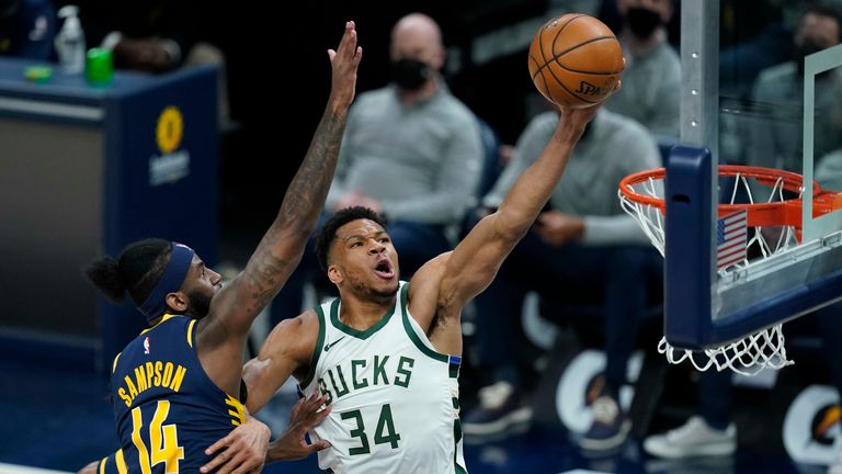 Milwaukee Bucks&#39; Giannis Antetokounmpo (34) dunks against Indiana Pacers&#39; JaKarr Sampson (14) during the second half of an NBA basketball game Thursday, May 13, 2021, in Indianapolis. 