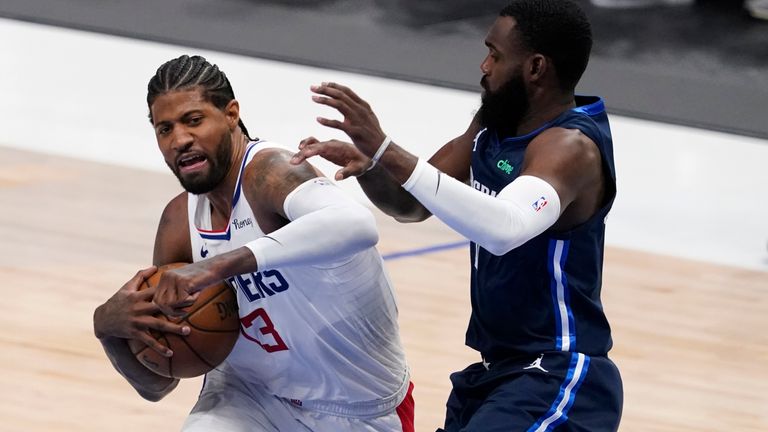 Los Angeles Clippers guard Paul George (13) fights to the basket against Dallas Mavericks&#39; Tim Hardaway Jr, right, in the first half in Game 3 of an NBA basketball first-round playoff series in Dallas, Friday, May 28, 2021. 