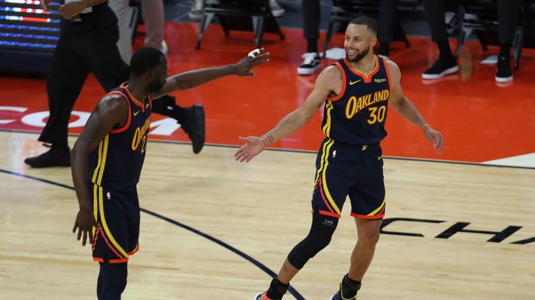 Golden State Warriors&#39; Stephen Curry, right, is congratulated by teammate Draymond Green during the first half of an NBA basketball Western Conference play-in game against the Memphis Grizzlies in San Francisco, Friday, May 21, 2021. (AP Photo/Jed Jacobsohn)


