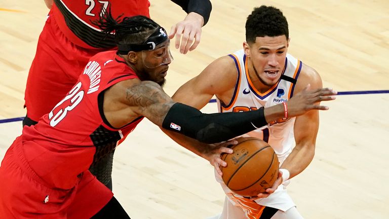 Phoenix Suns guard Devin Booker drives at Portland Trail Blazers forward Robert Covington