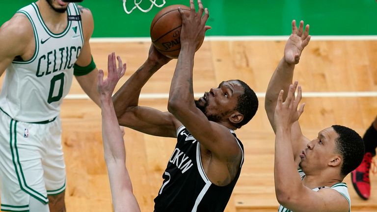 Brooklyn Nets forward Kevin Durant (7) goes to the hoop against Boston Celtics guard Payton Pritchard (11), forward Grant Williams (12) and forward Jayson Tatum (0) in the first half of Game 4 during an NBA basketball first-round playoff series, Sunday, May 30, 2021, in Boston. 