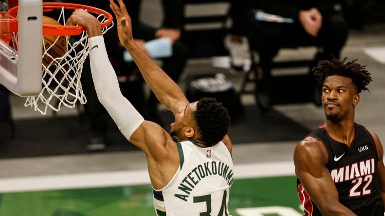 Milwaukee Bucks forward Giannis Antetokounmpo (34) dunks as Miami Heat forward Jimmy Butler (22) watches during the second half of Game 2 of their NBA basketball first-round playoff series Monday, May 24, 2021, in Milwaukee. 