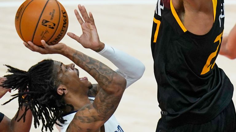 Memphis Grizzlies guard Ja Morant, left, shoots as Utah Jazz center Rudy Gobert, right, defends during the first half of Game 2 of an NBA basketball first-round playoff series Wednesday, May 26, 2021, in Salt Lake City. (AP Photo/Rick Bowmer)


