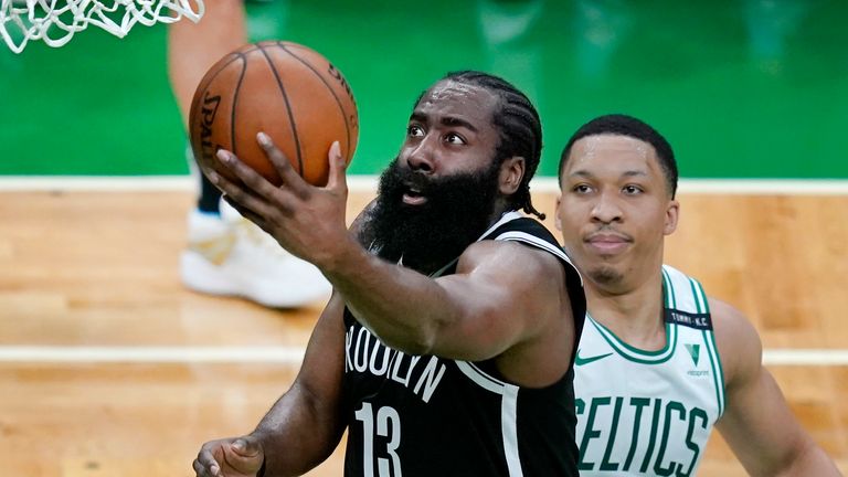 Brooklyn Nets guard James Harden (13) drives to the hoop past Boston Celtics forward Grant Williams (12) in the second quarter of Game 4 during an NBA basketball first-round playoff series, Sunday, May 30, 2021, in Boston. 