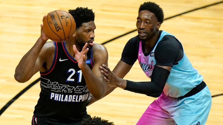 Miami Heat center Bam Adebayo, right, defends Philadelphia 76ers center Joel Embiid (21) during the first half of an NBA basketball game, Thursday, May 13, 2021, in Miami.