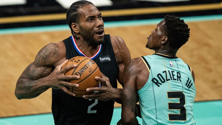 Los Angeles Clippers forward Kawhi Leonard (2) drives to the basket and is fouled by Charlotte Hornets guard Terry Rozier (3) during the first half of an NBA basketball game in Charlotte, N.C., Thursday, May 13, 2021.