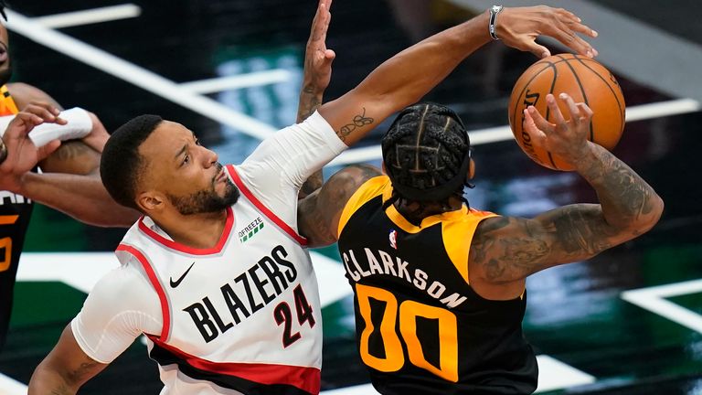 Portland Trail Blazers forward Norman Powell (24) defends against Utah Jazz guard Jordan Clarkson (00) during the first half of an NBA basketball game Wednesday, May 12, 2021, in Salt Lake City. 