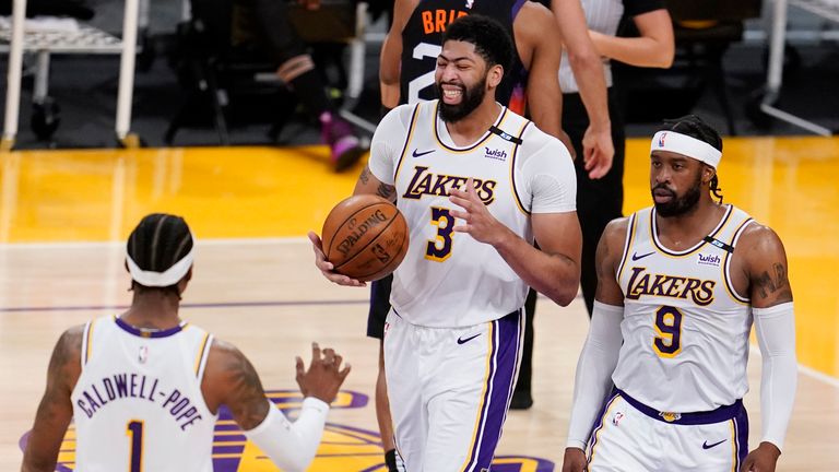 Los Angeles Lakers forward Anthony Davis (3) reacts after scoring next to teammates Kentavious Caldwell-Pope, left, Wesley Matthews (9) during the second half of an NBA basketball game against the Phoenix Suns on Sunday, May 9, 2021, in Los Angeles. (AP Photo/Marcio Jose Sanchez)


