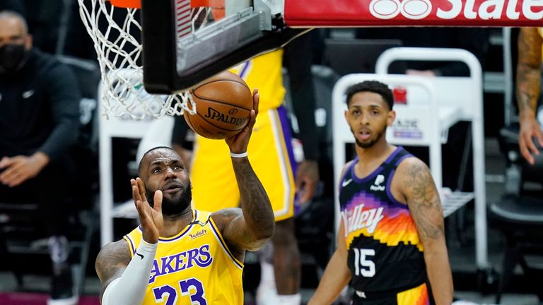 Los Angeles Lakers forward LeBron James (23) scores as Phoenix Suns guard Cameron Payne (15) looks on during the first half of Game 2 of their NBA basketball first-round playoff series Tuesday, May 25, 2021, in Phoenix. (AP Photo/Ross D. Franklin)


