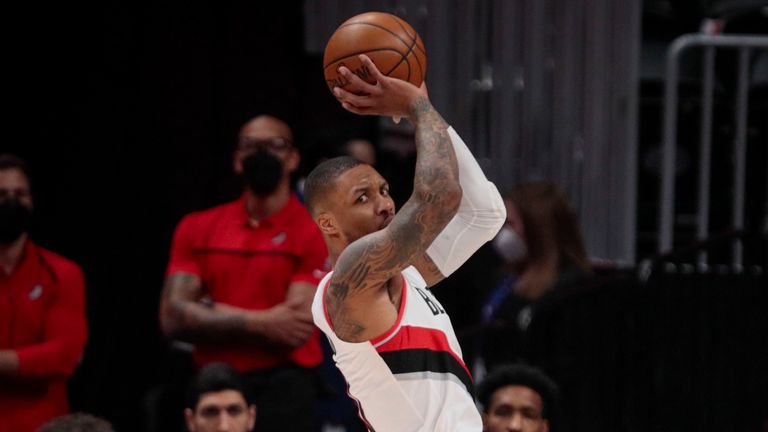 Portland Trail Blazers guard Damian Lillard (0) glances over his shoulder as he shoots against Denver Nuggets forward Aaron Gordon (50) in the first quarter of Game 2 of a first-round NBA basketball playoff series Monday, May 24, 2021, in Denver.