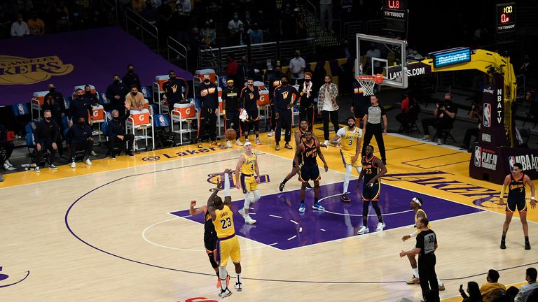 LeBron James hits a deep three-pointer over Steph Curry with a minute remaining in the fourth quarter and only 00.8 seconds on the shot clock. 