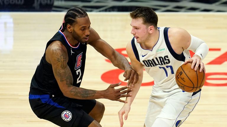 Dallas Mavericks guard Luka Doncic (77) is guarded by Los Angeles Clippers forward Kawhi Leonard (2) during the second half in Game 2 of an NBA basketball first-round playoff series Tuesday, May 25, 2021, in Los Angeles. (AP Photo/Marcio Jose Sanchez)


