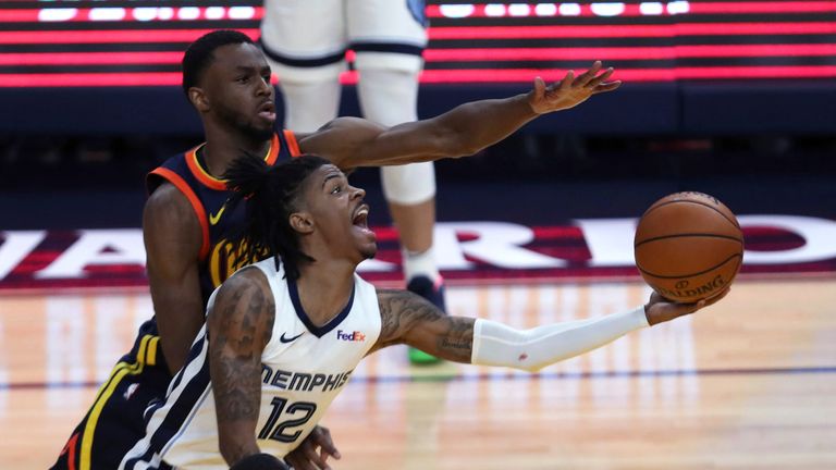 Memphis Grizzlies&#39; Ja Morant (12) shoots against Golden State Warriors&#39; Andrew Wiggins during the second half of an NBA basketball Western Conference play-in game in San Francisco, Friday, May 21, 2021. (AP Photo/Jed Jacobsohn)


